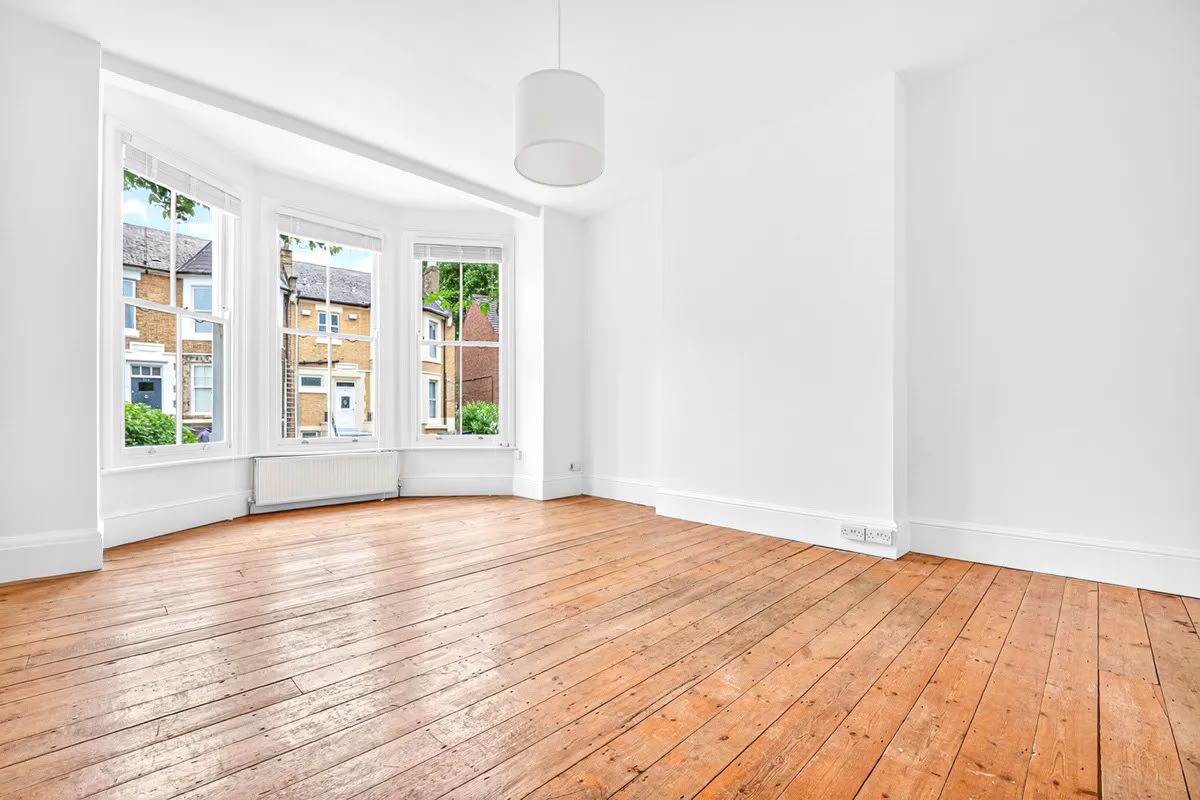 Bay-fronted living room with restored pine floorboards